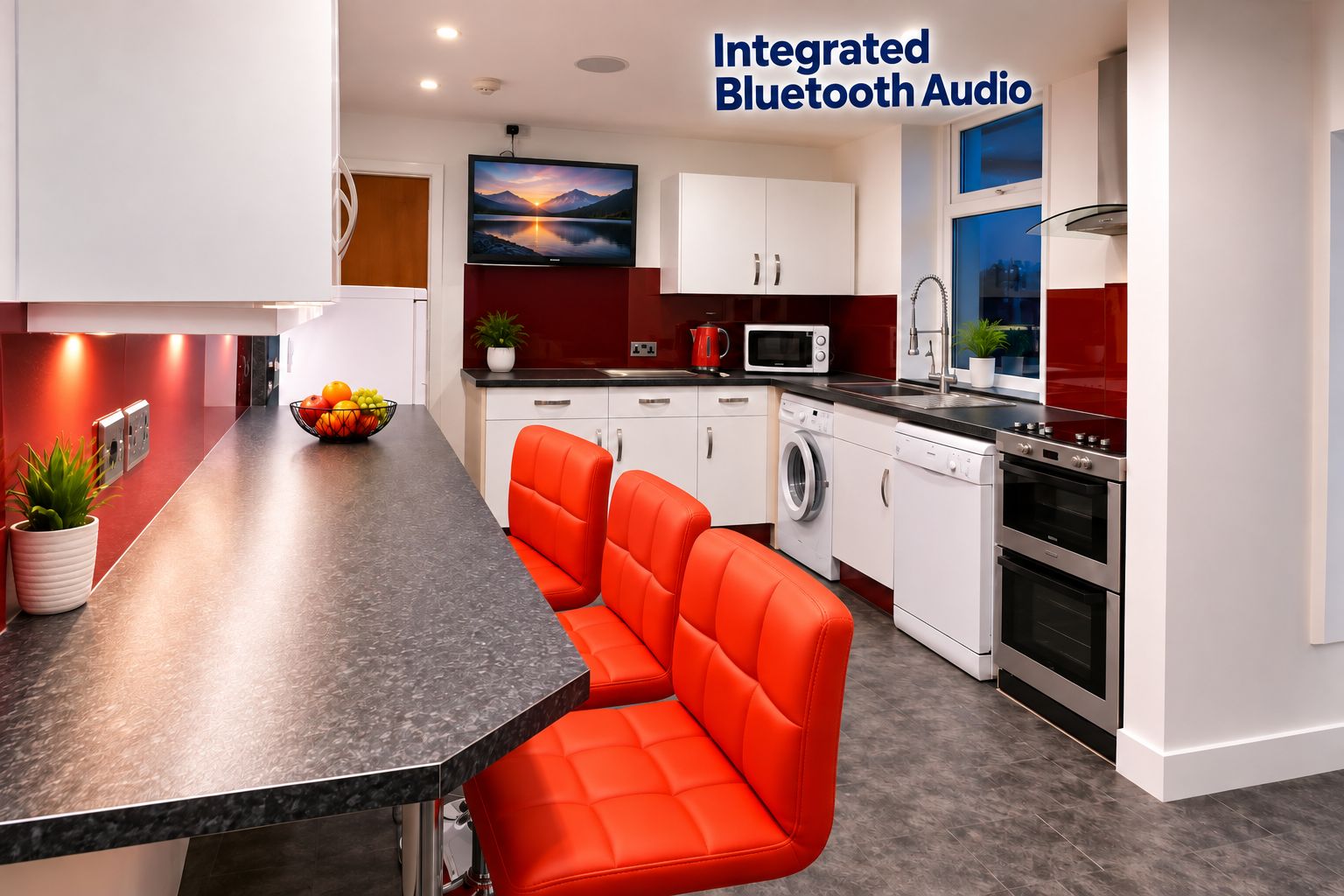 Home 22 Student kitchen in Lancaster accommodation with red bar stools, integrated appliances and wall-mounted TV with Bluetooth audio